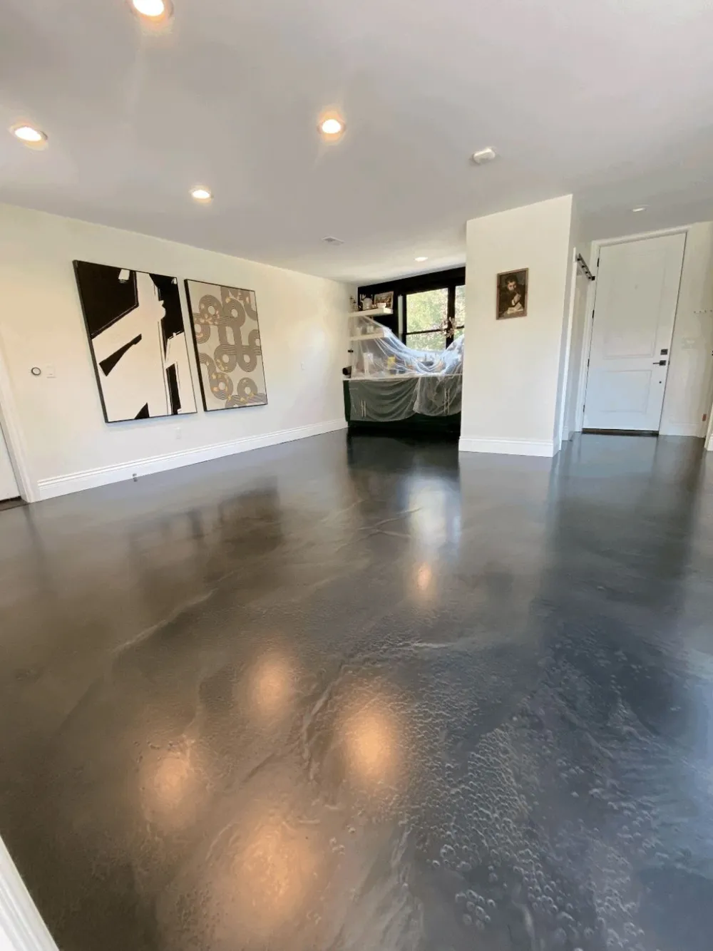 Dark stained and sealed concrete floor in a finished Denver basement living space
