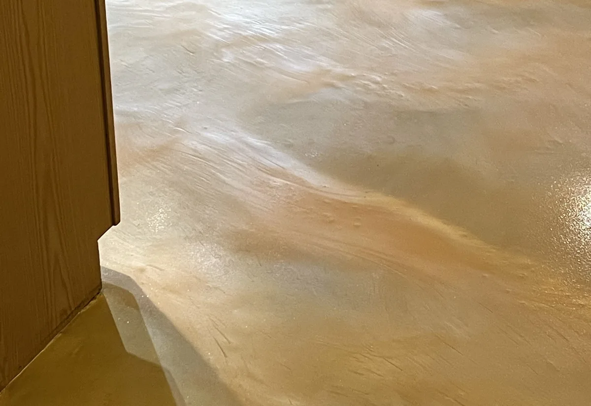 Three-color metallic epoxy floor with a urethane top coat beside oak cabinets