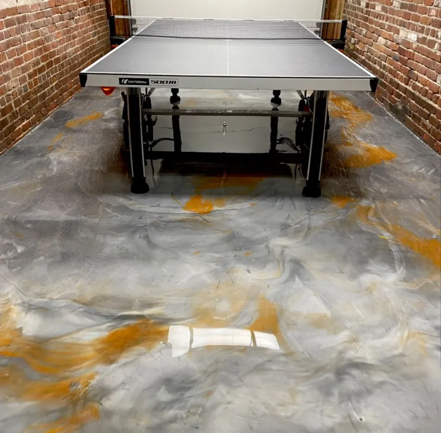 Gray and gold marbled metallic floor in a finished game room